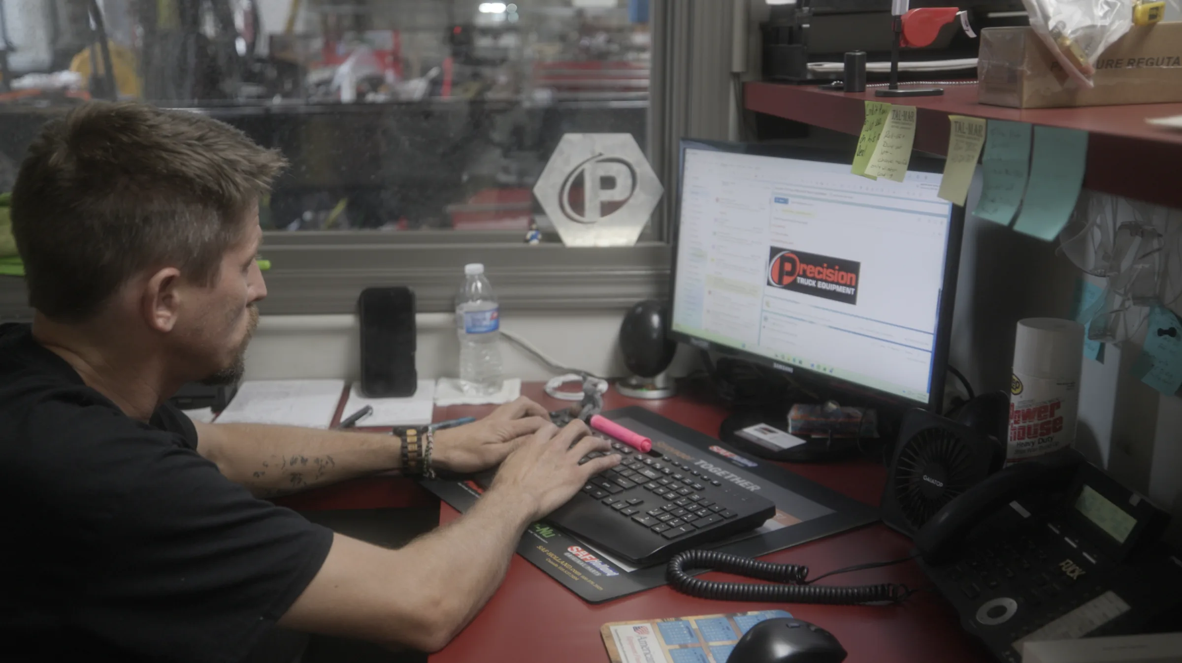 Team member working at a computer in the shop office