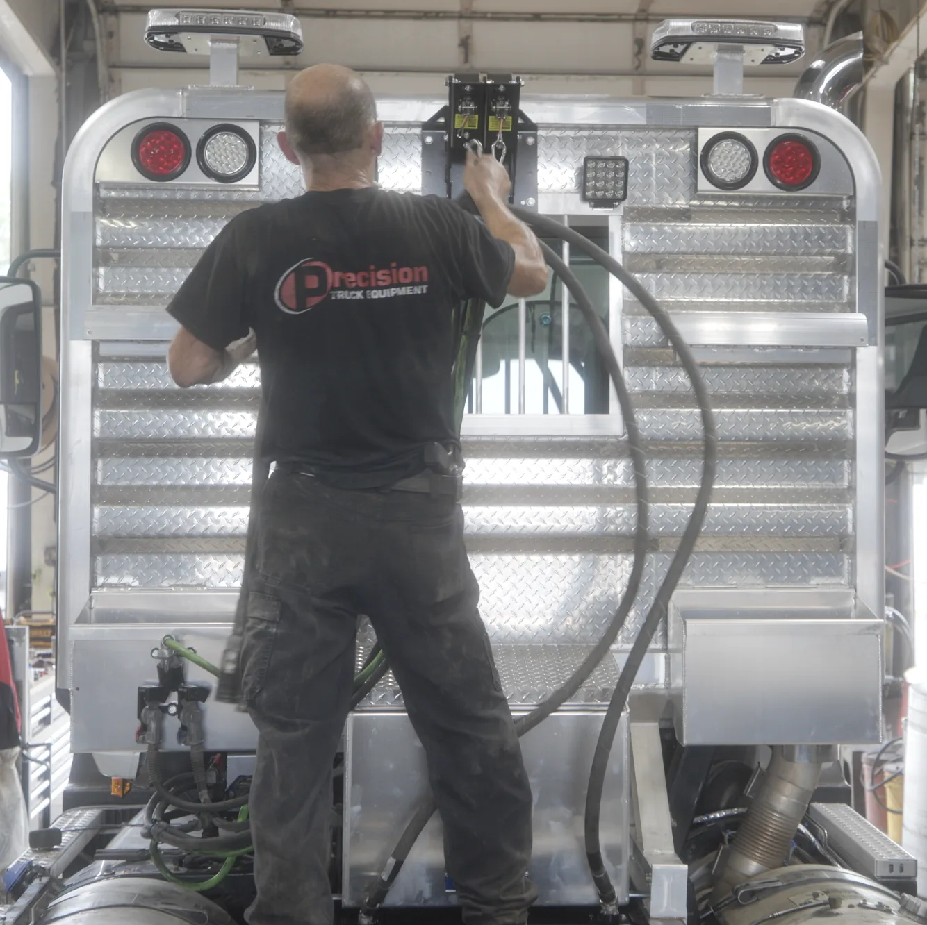 Precision technician installing a polished aluminum headache rack