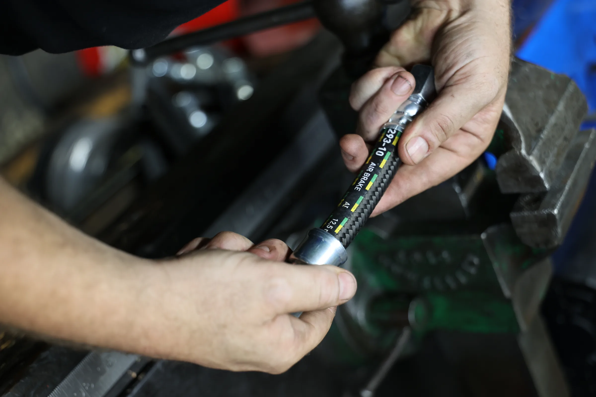 Precision technician preparing a custom hydraulic hose