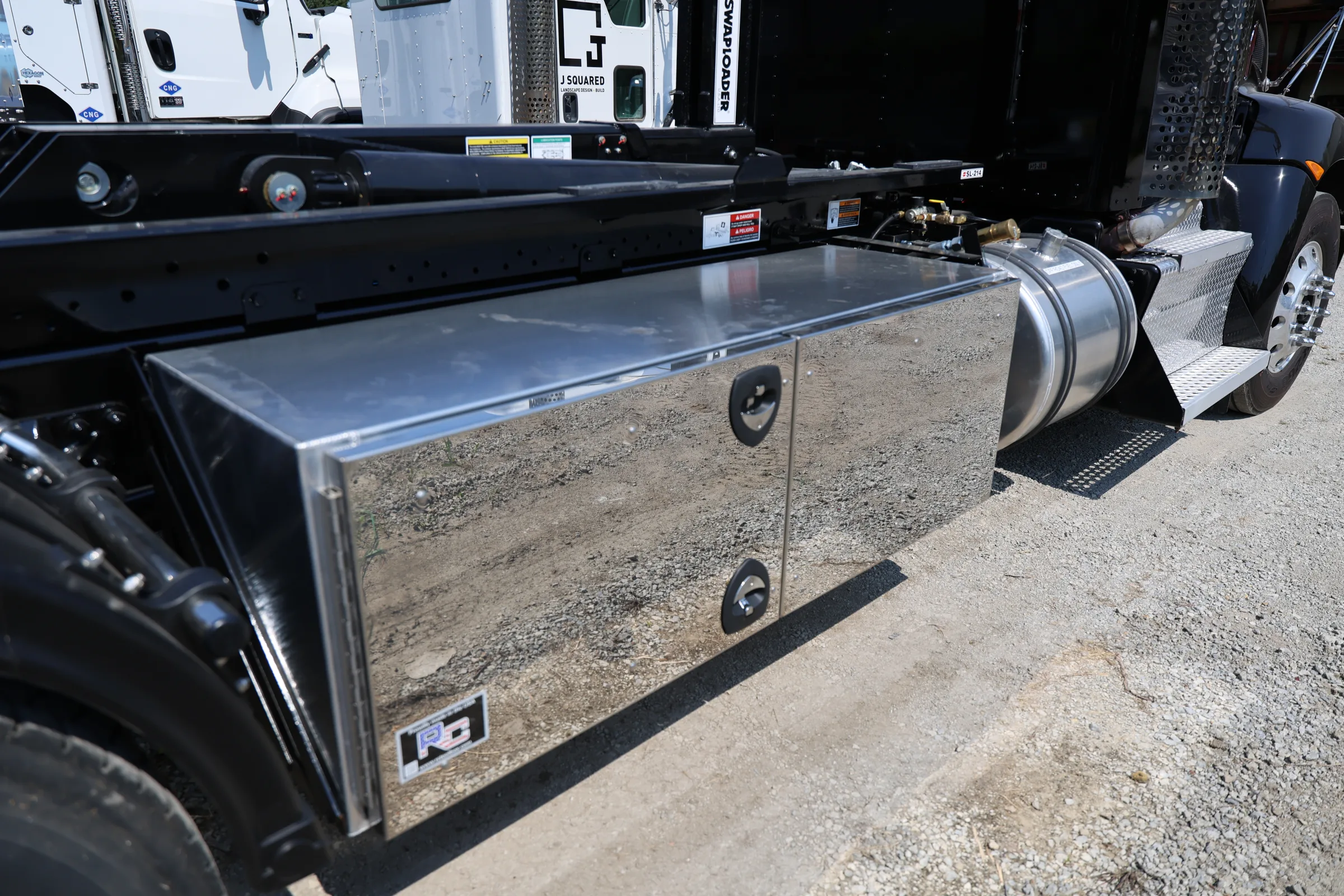 Polished aluminum toolbox mounted on a commercial truck