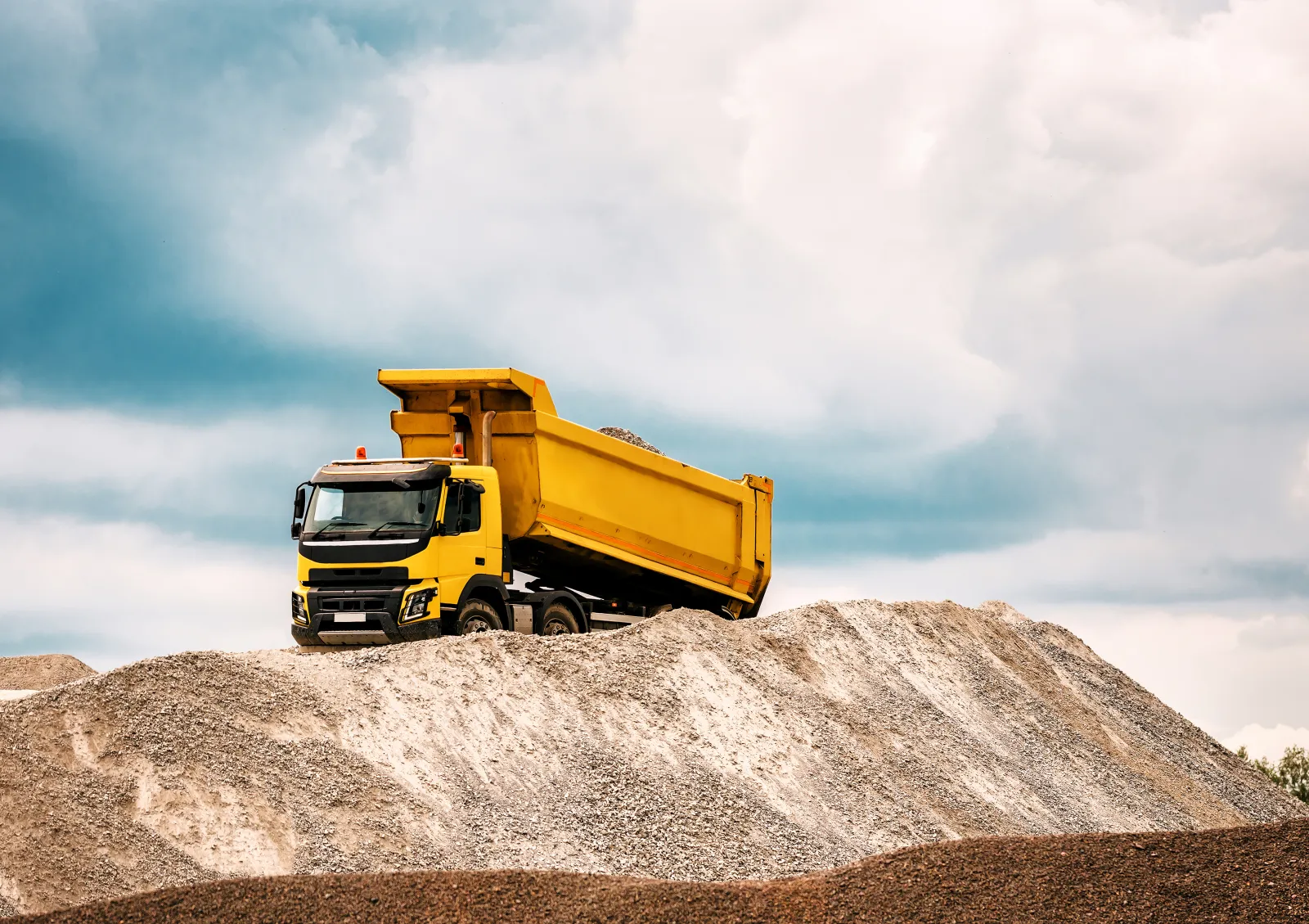 Yellow dump truck with raised dump body